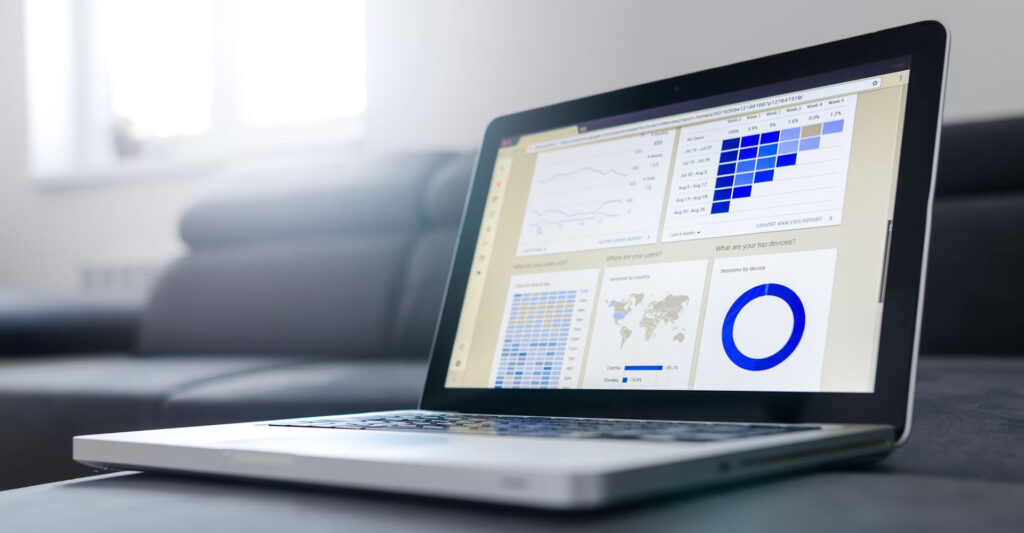 A close-up of a laptop screen displaying Google Analytics graphs, illustrating data analysis for business improvement.